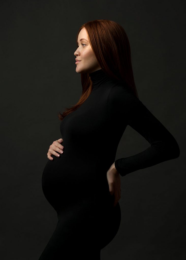 black fitted turtleneck dress pregnant woman