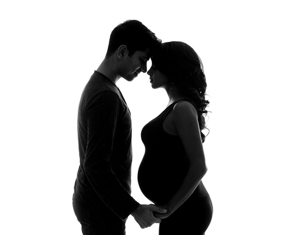 couple holding hands pregnant for maternity photo shoot
