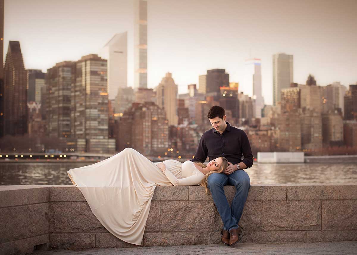 Couples portrait of a pregnant woman and her husband with NYC skyline.