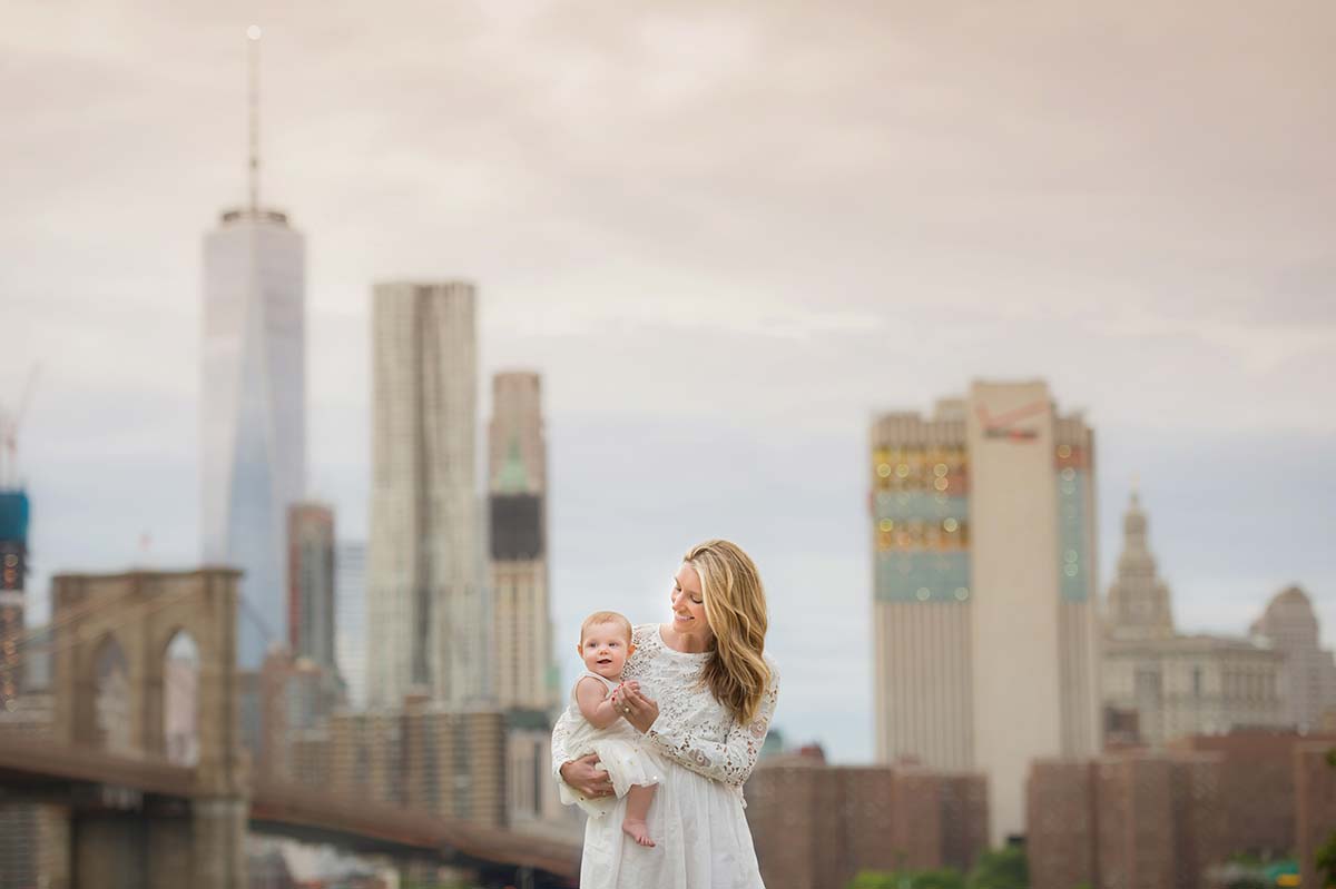 A stylish Mom playing with her baby near NYC Downtown