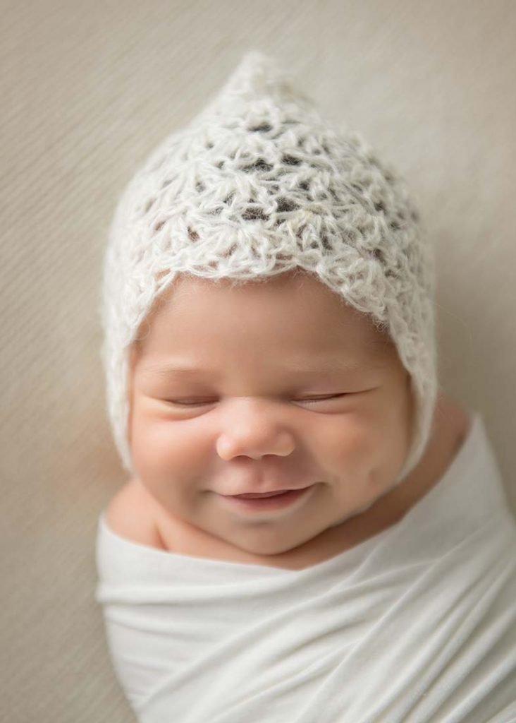Cute baby in a hat smiling