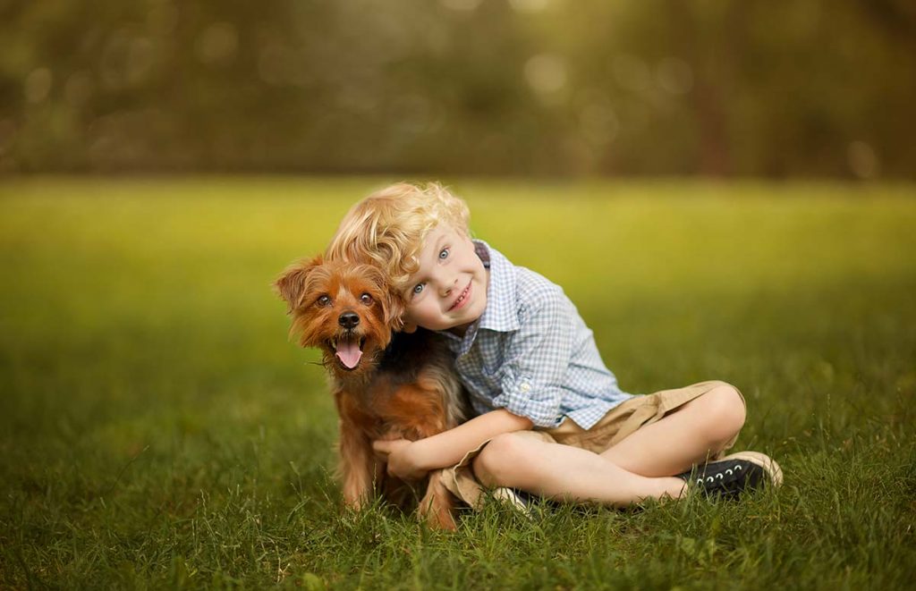 Boy posing with his pet dog in Central Park