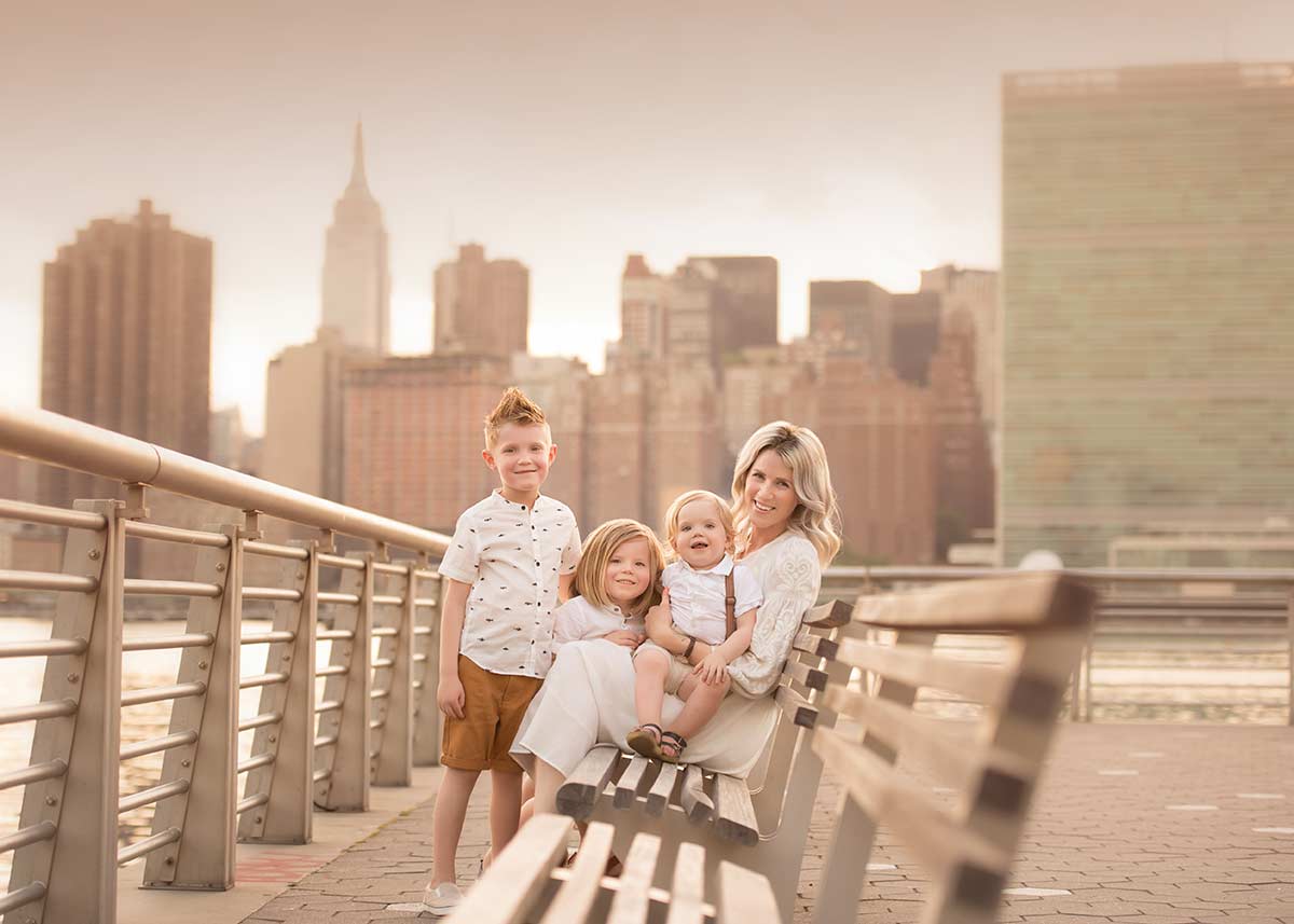 Three boys and their mother posing for a family portrait in NYC