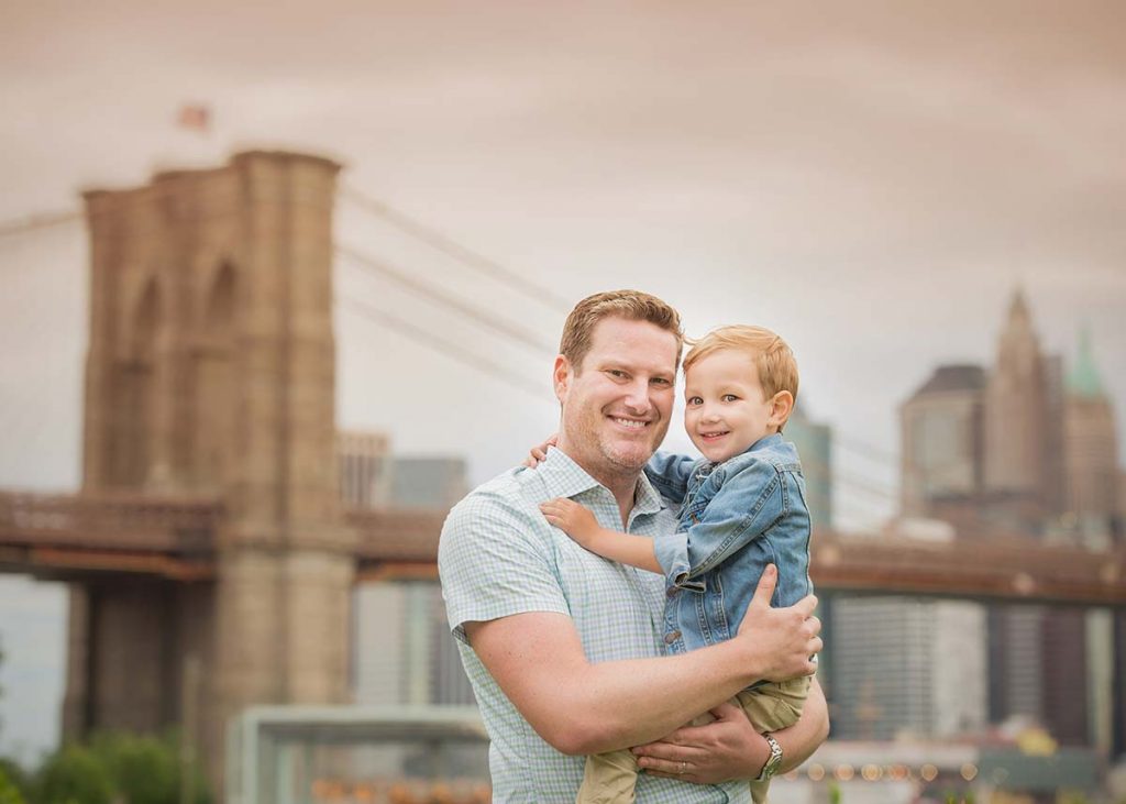 Father and his toddler boy posing for photos near Brooklyn Bridge
