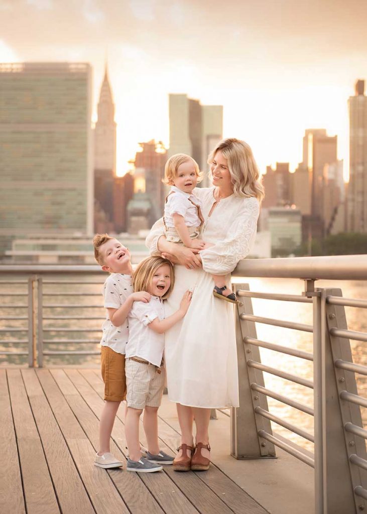 Mother posing with her children by a NYC waterside park