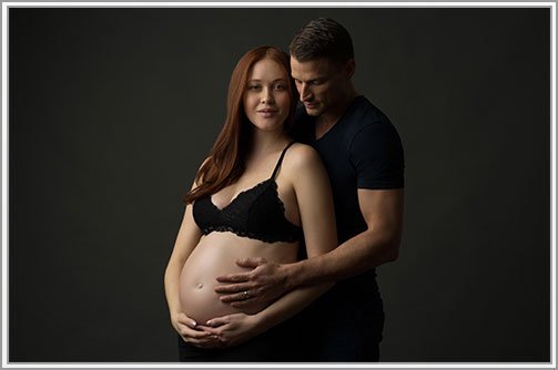 Father holding his wife's pregnant belly in a maternity photo studio NYC