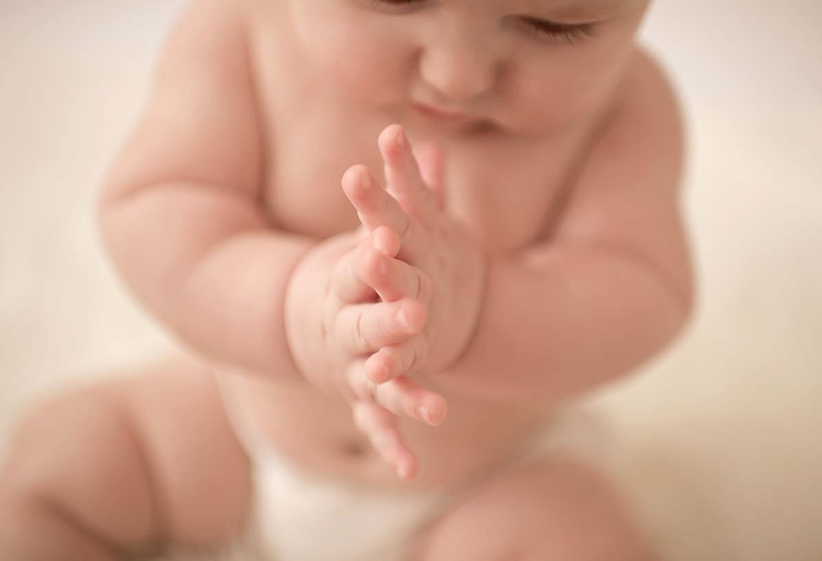 Closeup of hands of a baby in a photo studio