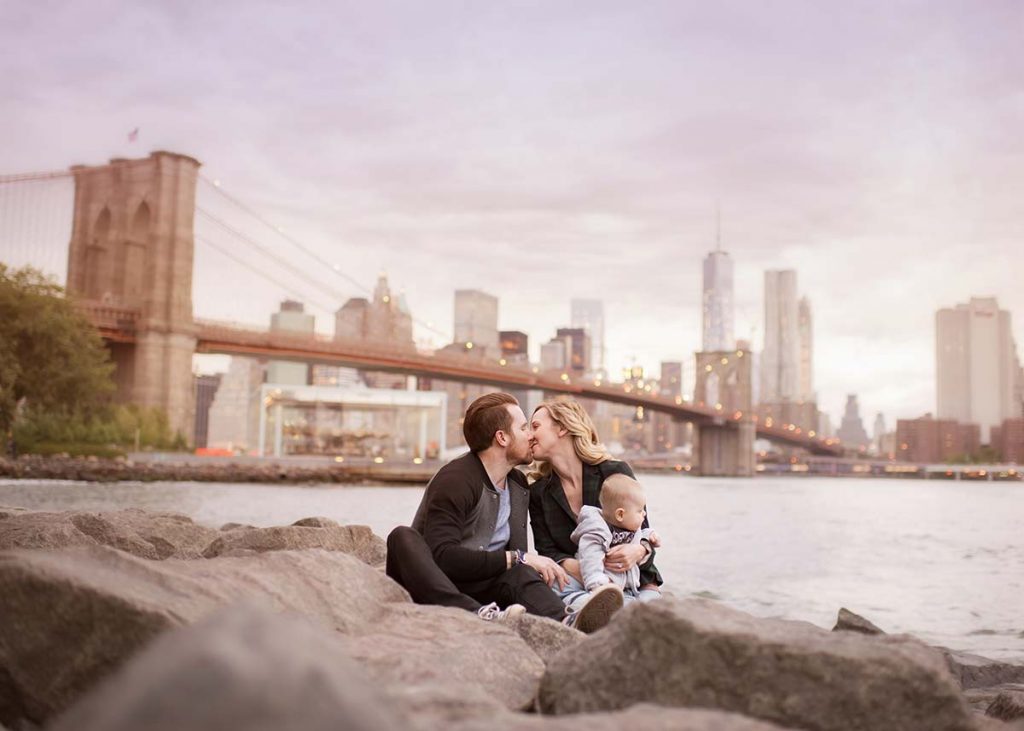 Brooklyn Family sitting on the shore near East River NYC