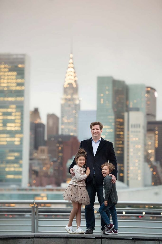 Father posing with his beautiful children with the Chrysler Building in the background