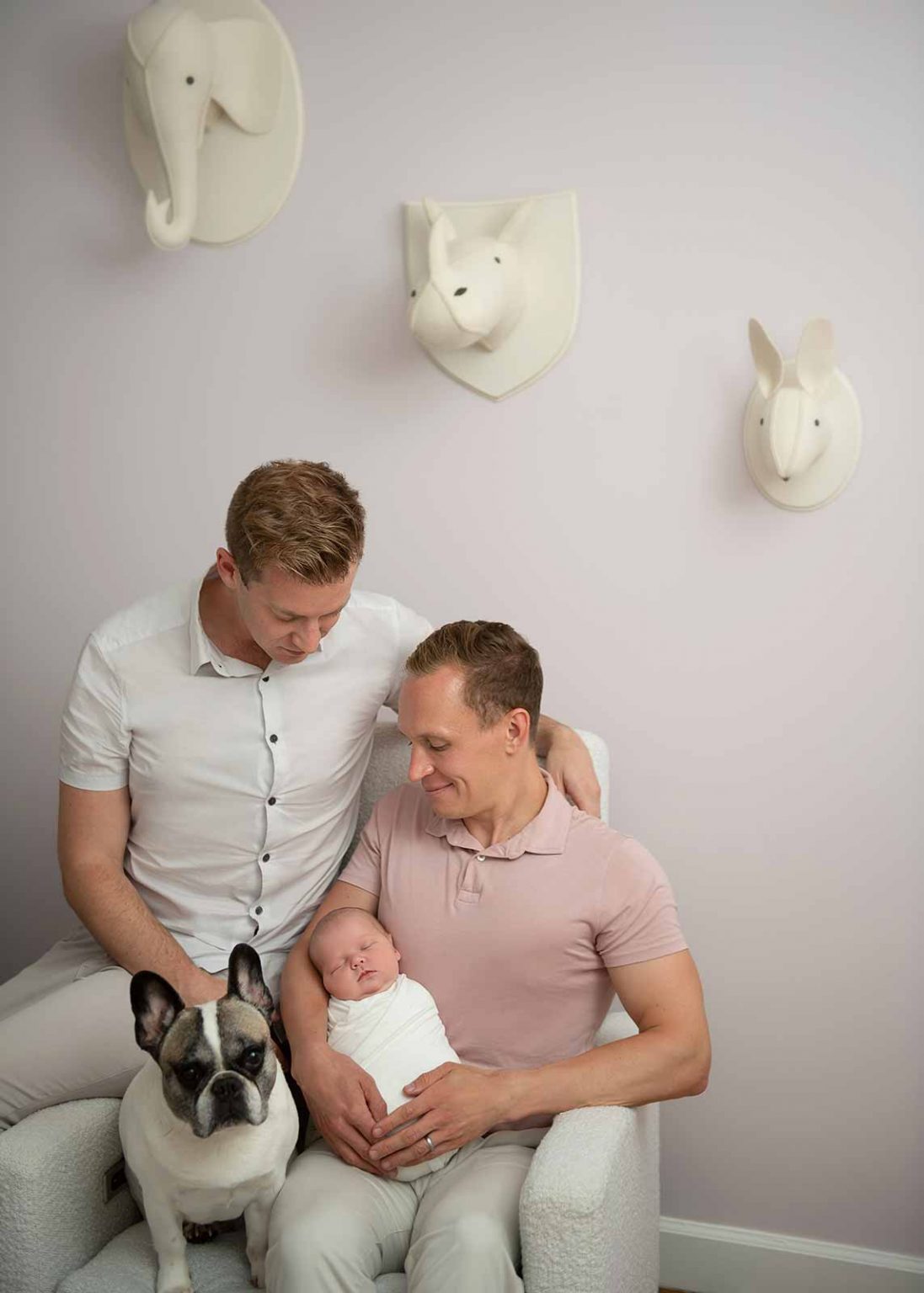 Parents cuddling their newborn baby girl