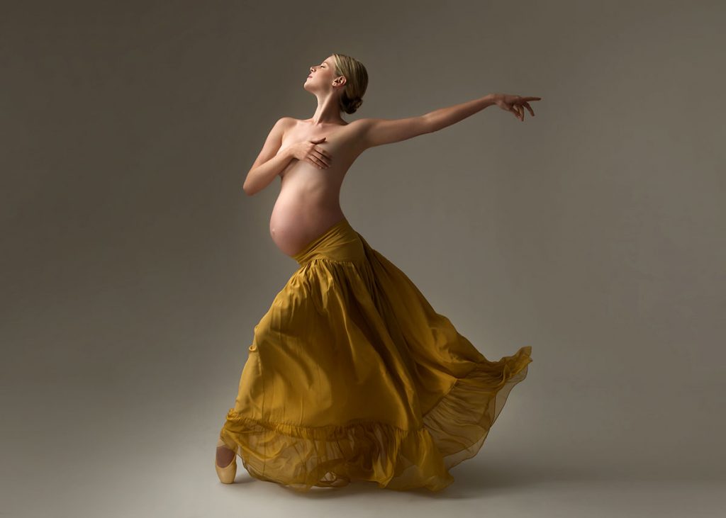Pregnant ballerina in a yellow skirt