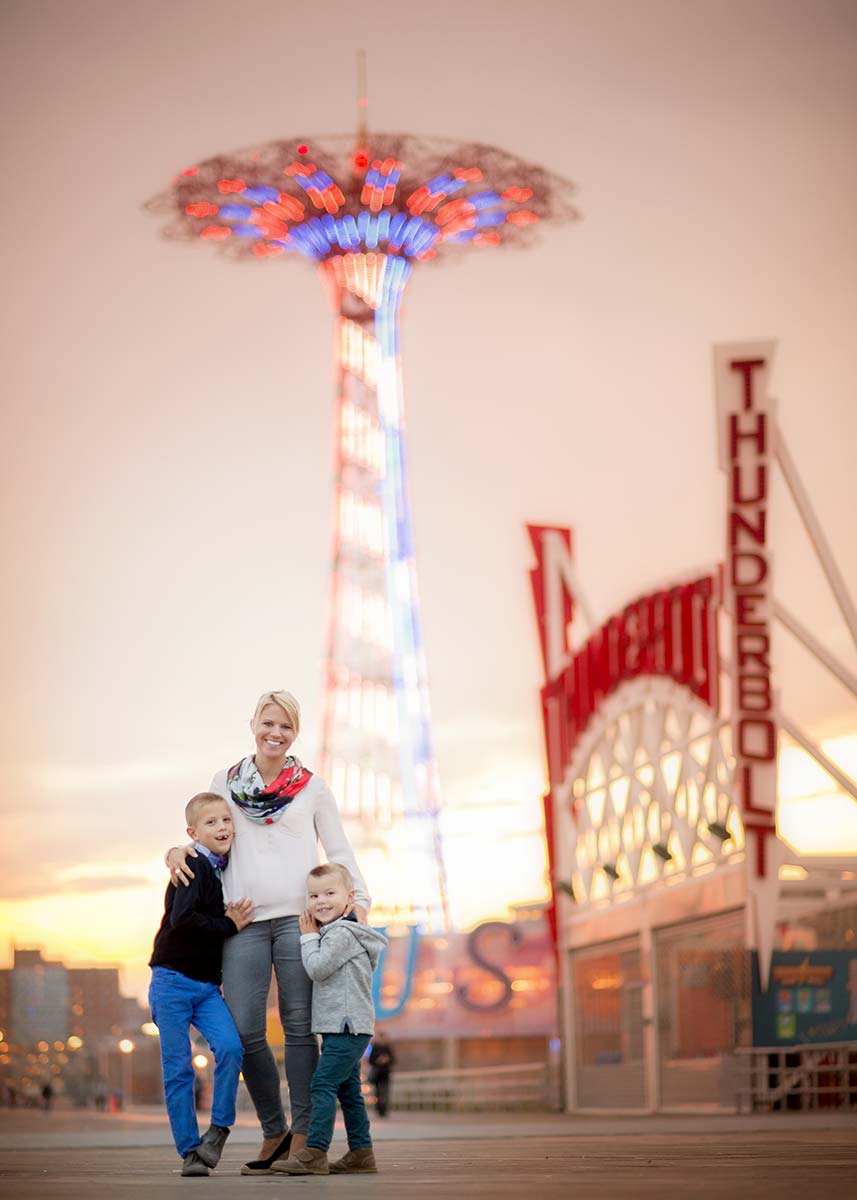 Mother with two sons standing on the boardwalk at Coney Island