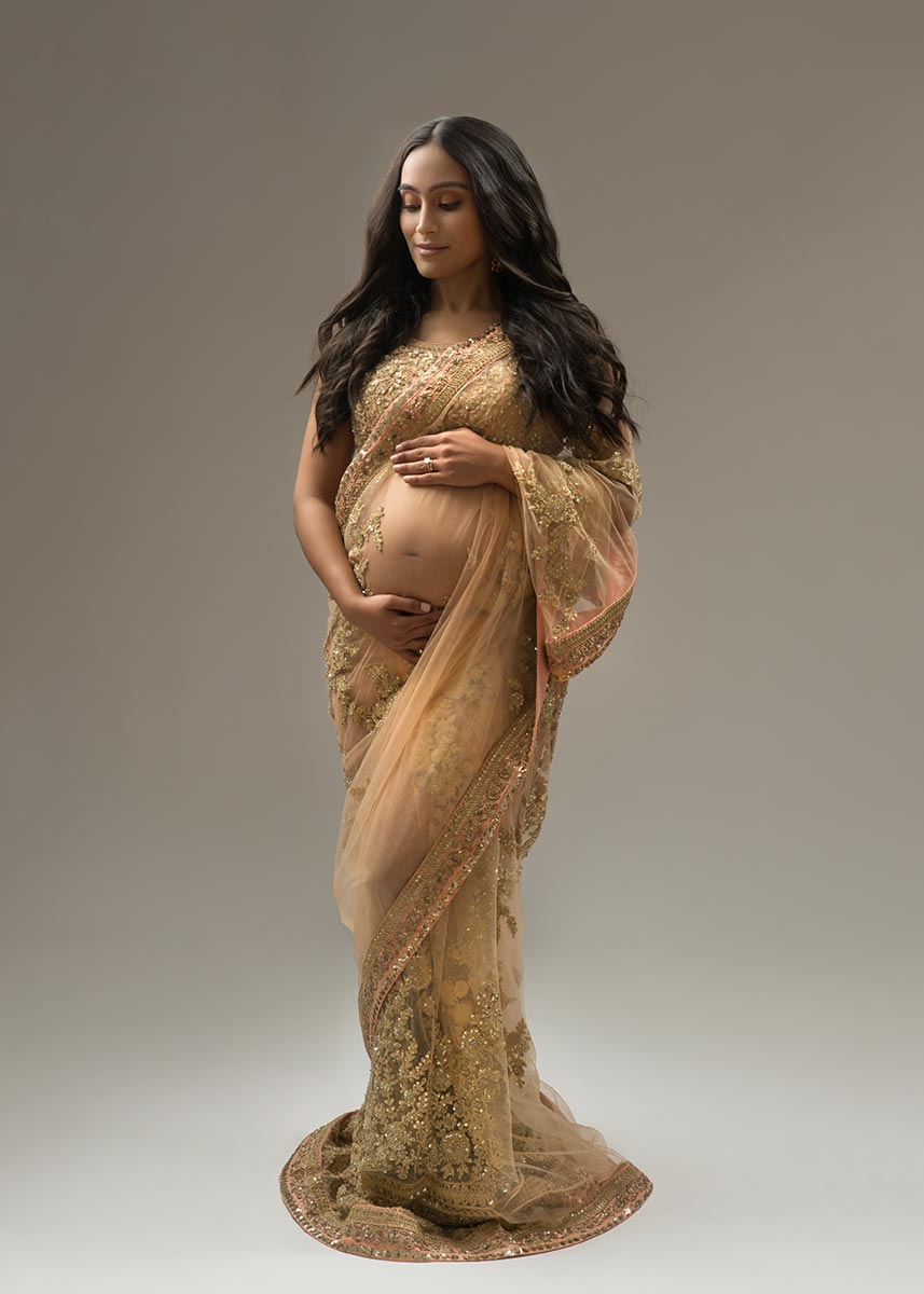 Pregnant woman wearing a traditional indian dress