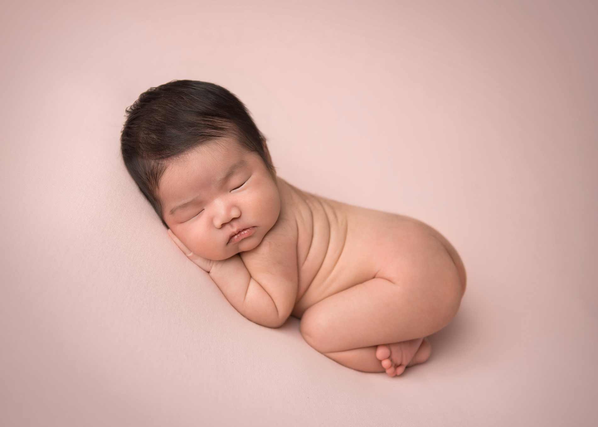 Baby sleeping on pink blanket