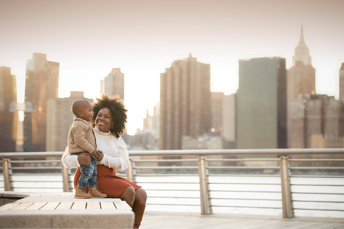 A mother shares a happy moment near the East River in NYC