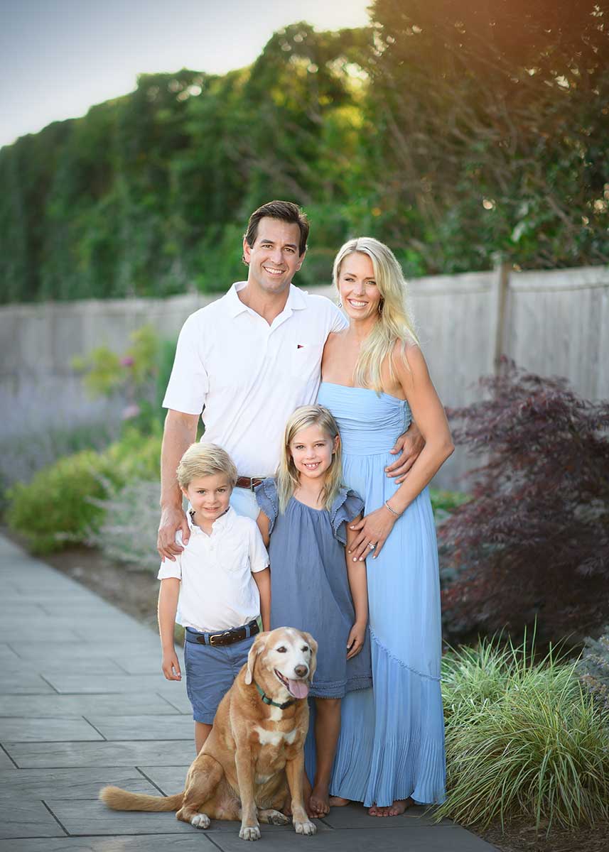 Modern NYC family posing for a portrait in their Hamptons home
