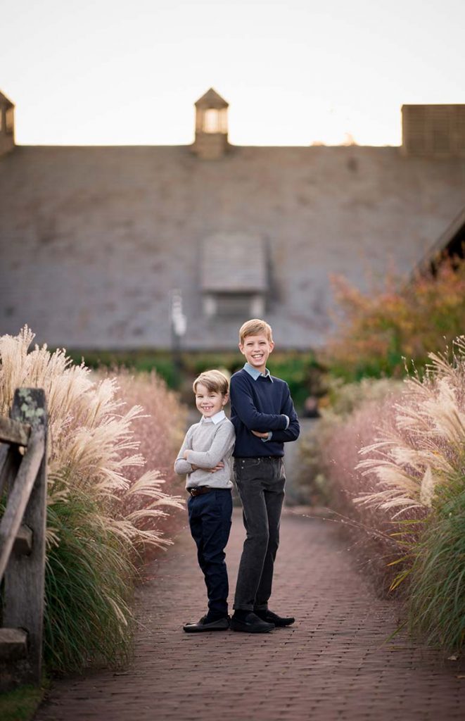 Two brothers standing on a brick path at a farm in Westchester County NY
