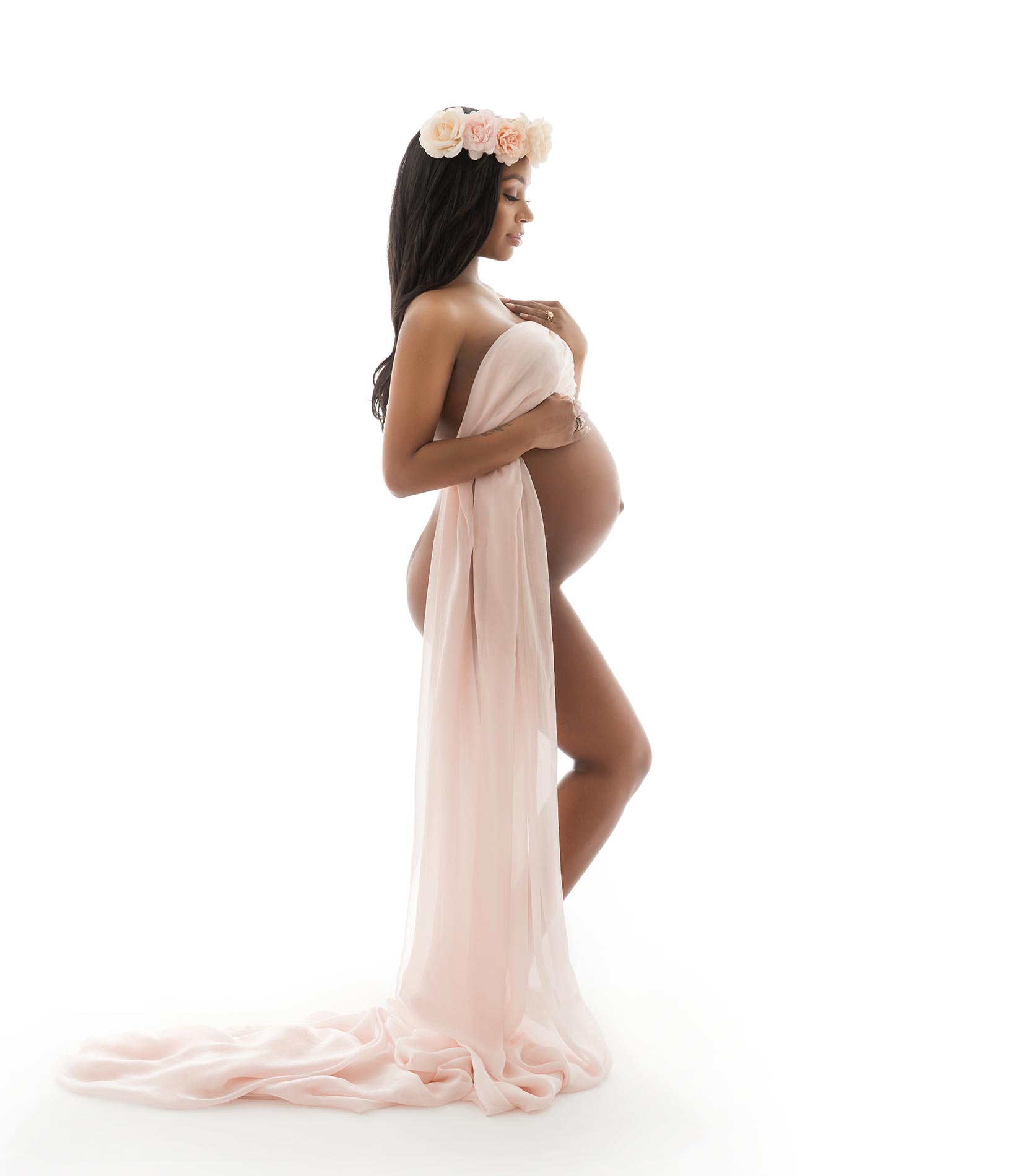 Pregnant woman draped in silk fabrics