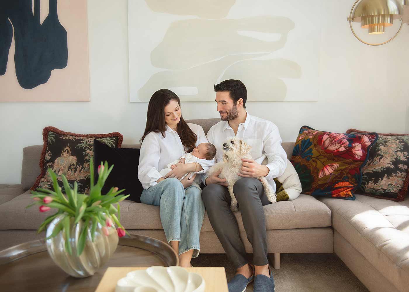 Mother and Father sharing a moment with their newborn baby at their NYC condominium