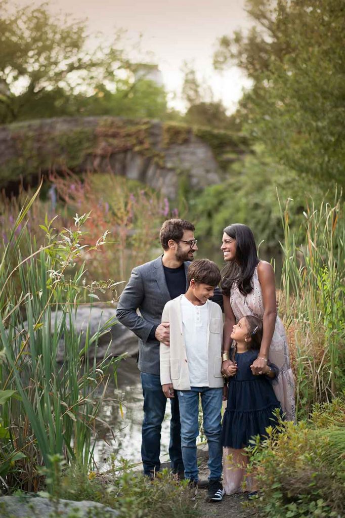 Family shares a happy laugh amongst tall grasses of Central Park