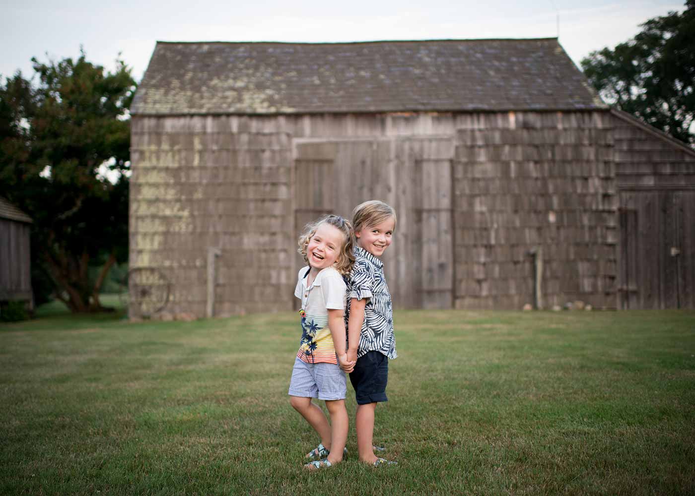 Two young boys sharing a laugh at a farm in the Hamptons