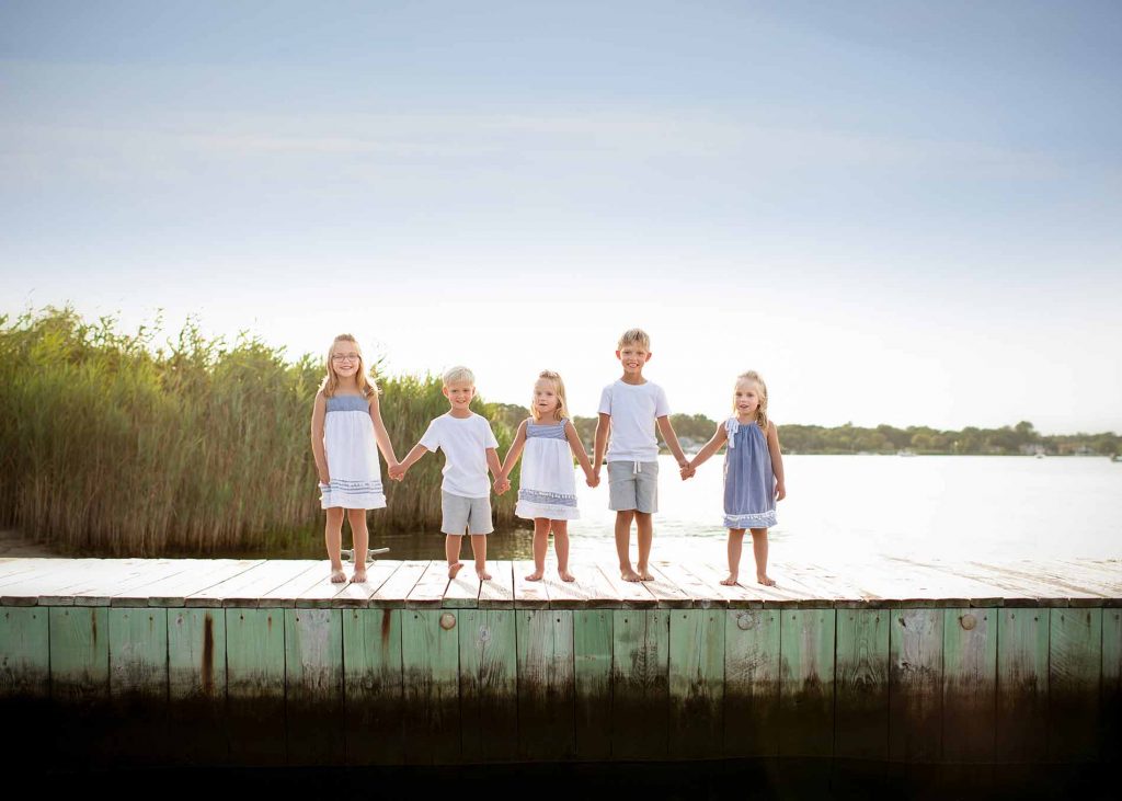 children-hamptons-dock-smiling Group of children holding hands on a boat dock near Sag Harbor, NY