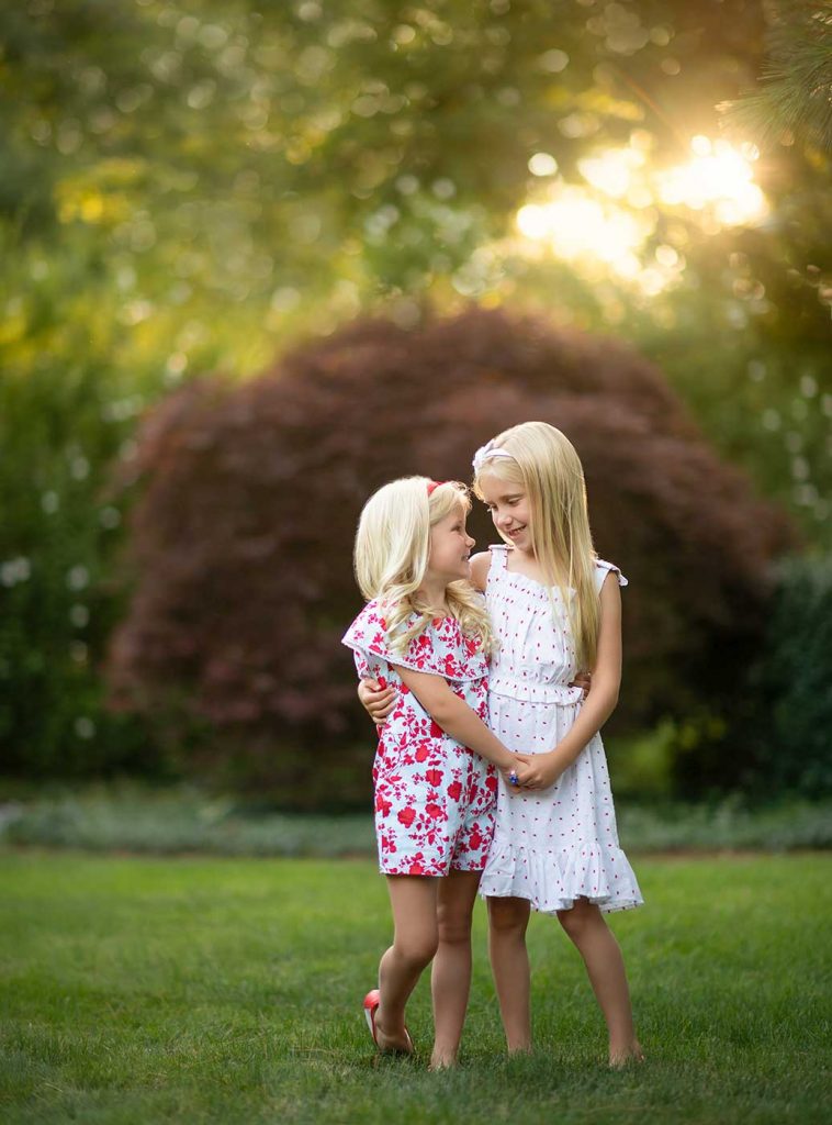 little-sisters-dancing-garden Two sisters holding hands in their Bridgehampton NY backyard
