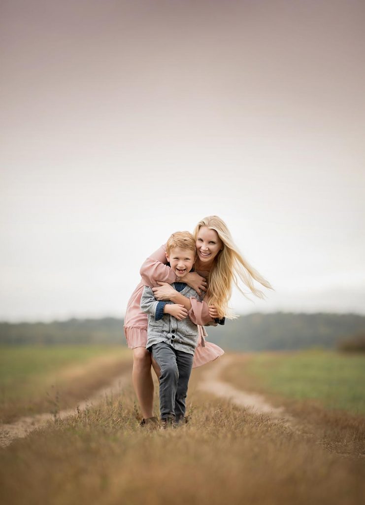 mother-hugging-son-farm Mother hugging her son in a field