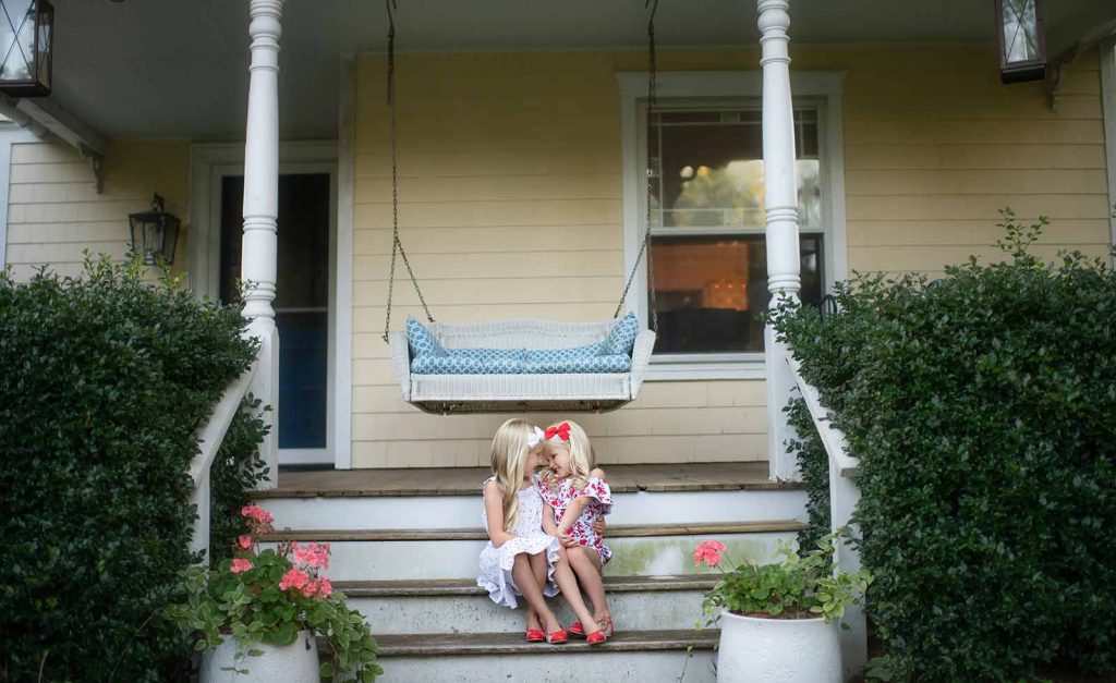 porch-bridgehampton-siblings Sisters sharing a laugh on the porch of their Bridgehampton NY home