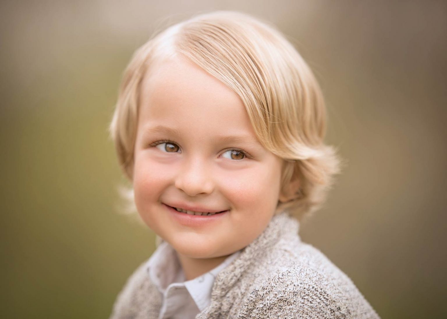 Smiling boy with blonde hair smiling in Sag Harbor NY