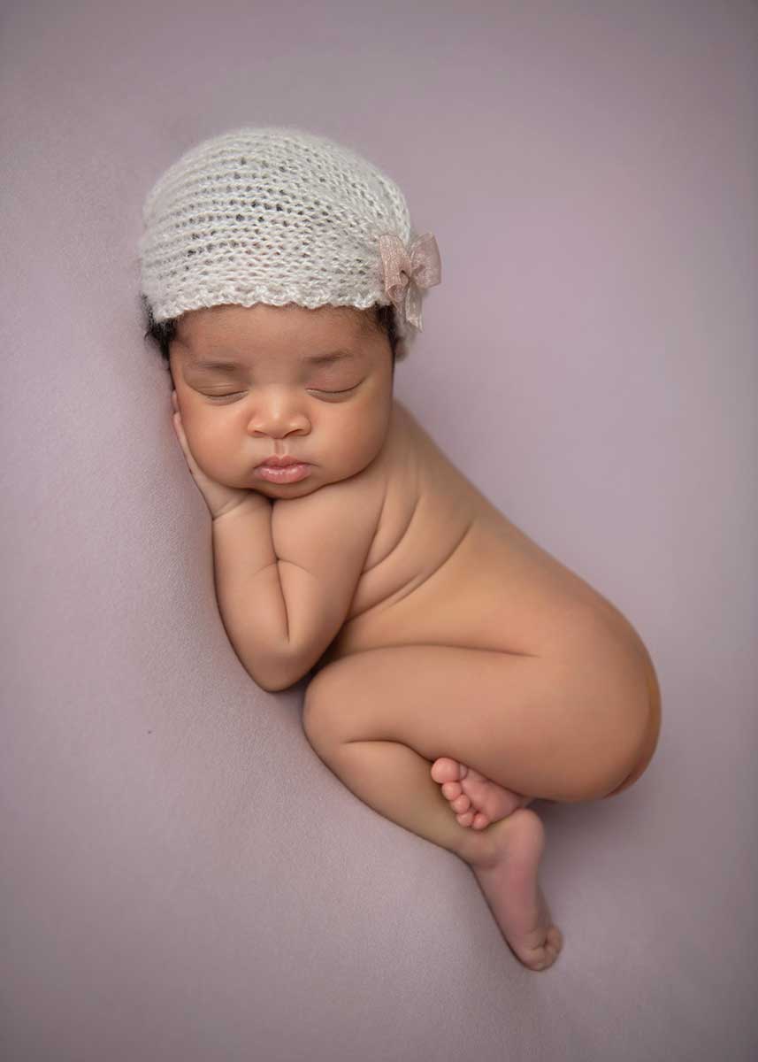 Baby with a cute hat as photographed at a NYC photo studio