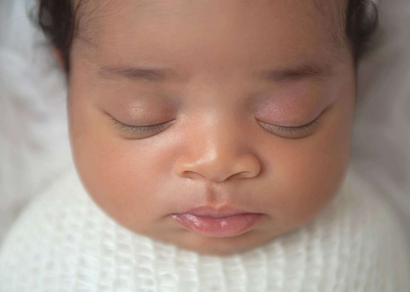 Closeup of a newborn baby's lips, eyes, and nose