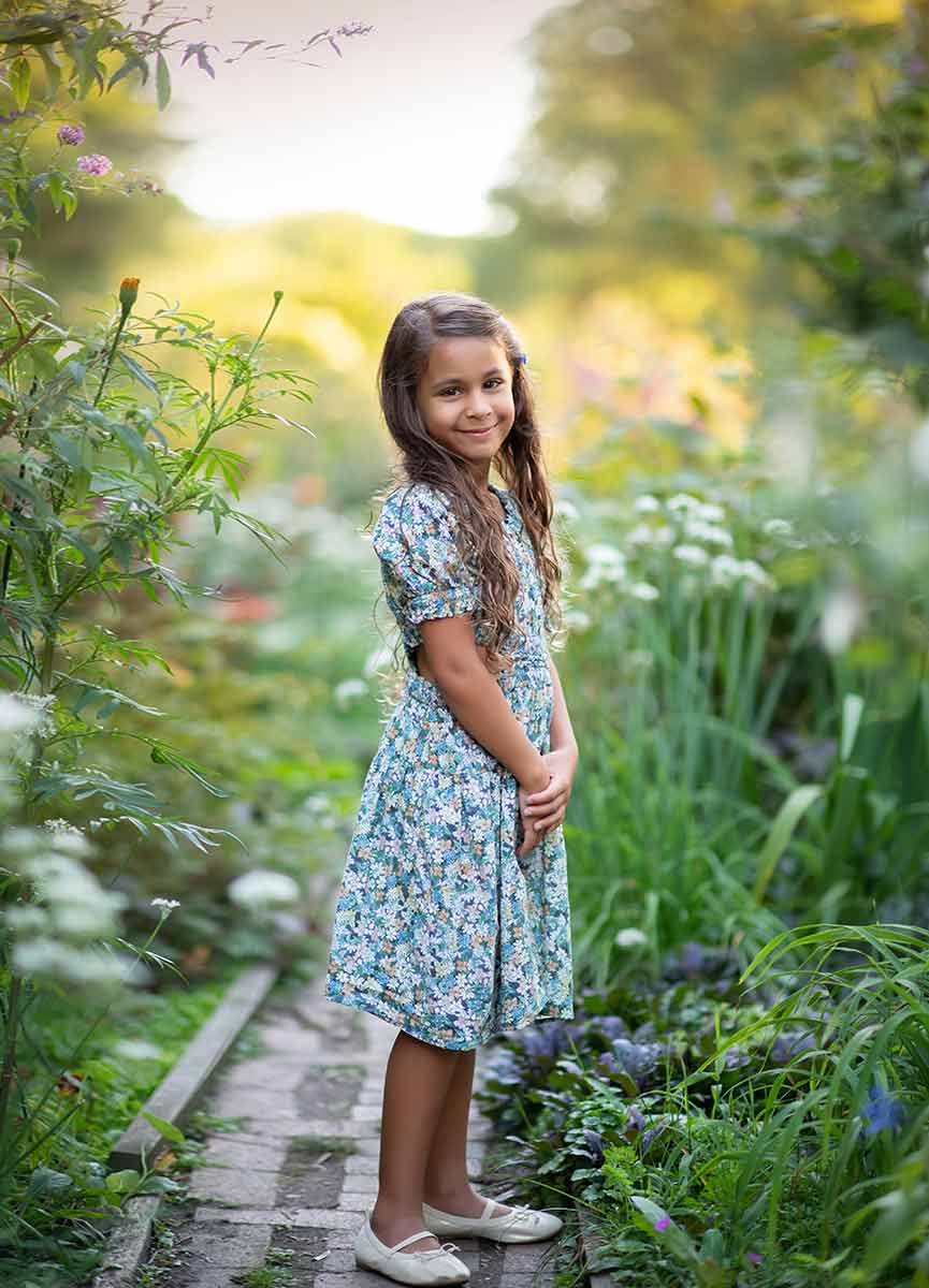 Girl in a flower dress standing in NYC's gardens