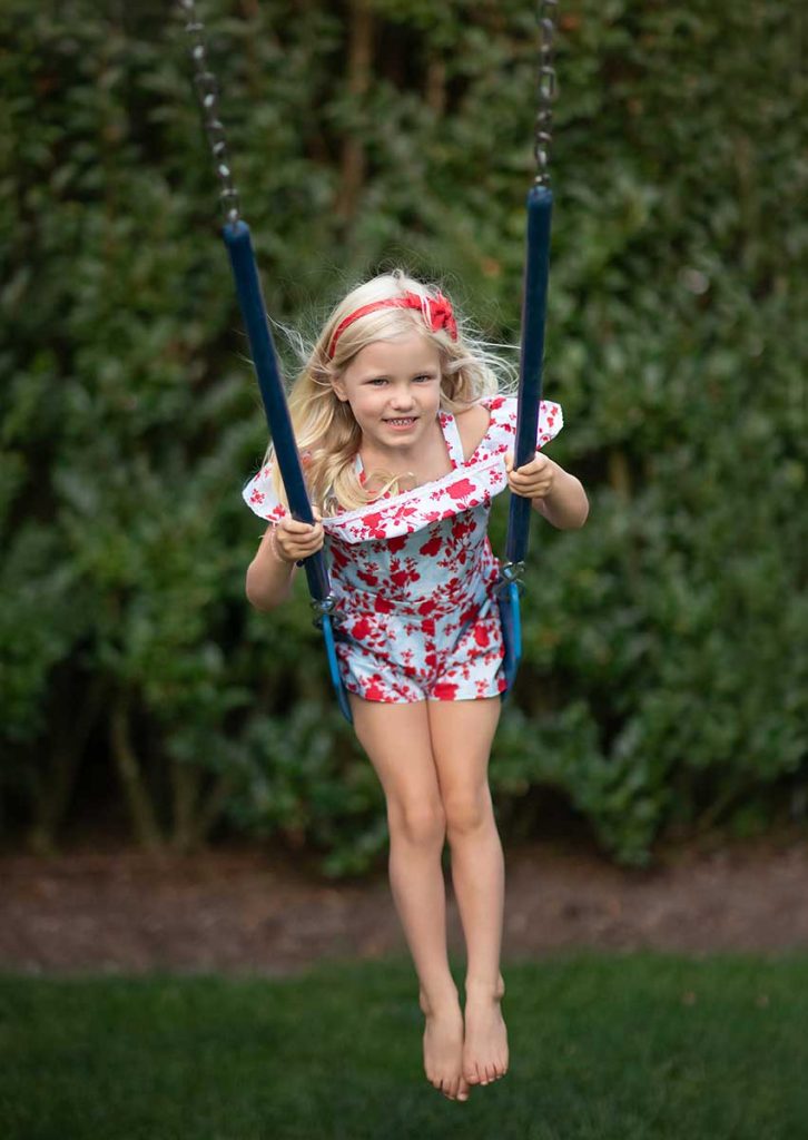 Girl smiling on a swing near Hamptons NY