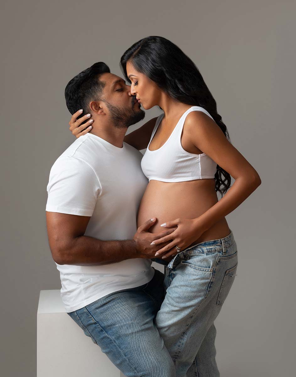 Candid maternity portrait between a husband and his wife