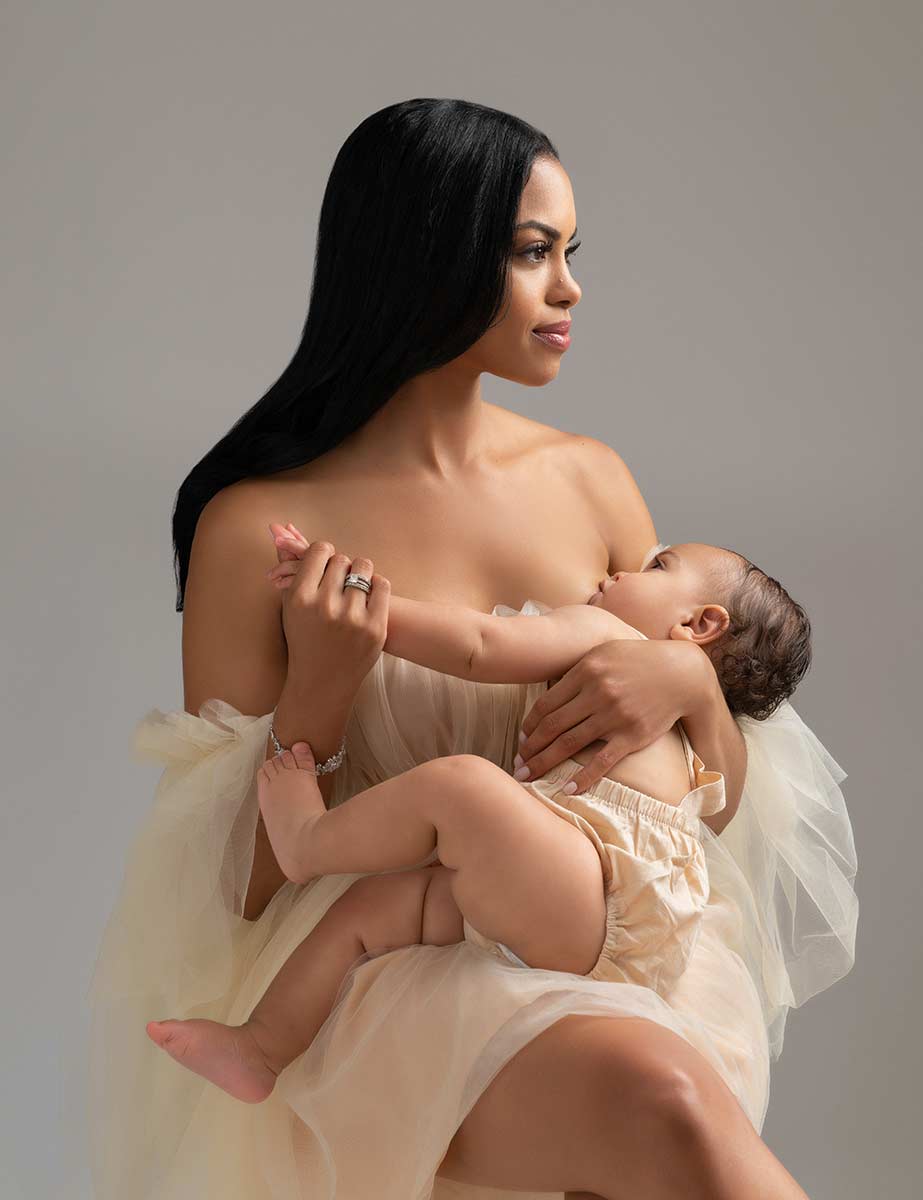 Fine art portrait of a mother breastfeeding her baby in a NYC studio