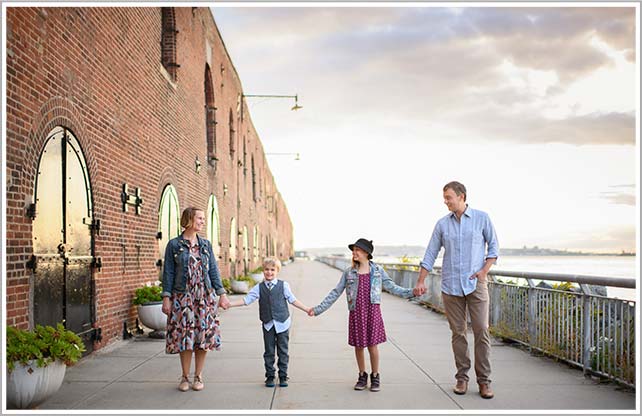 Family Photographer captures this timeless portrait of a family standing in Red Hook neighborhood of Brooklyn, NY.