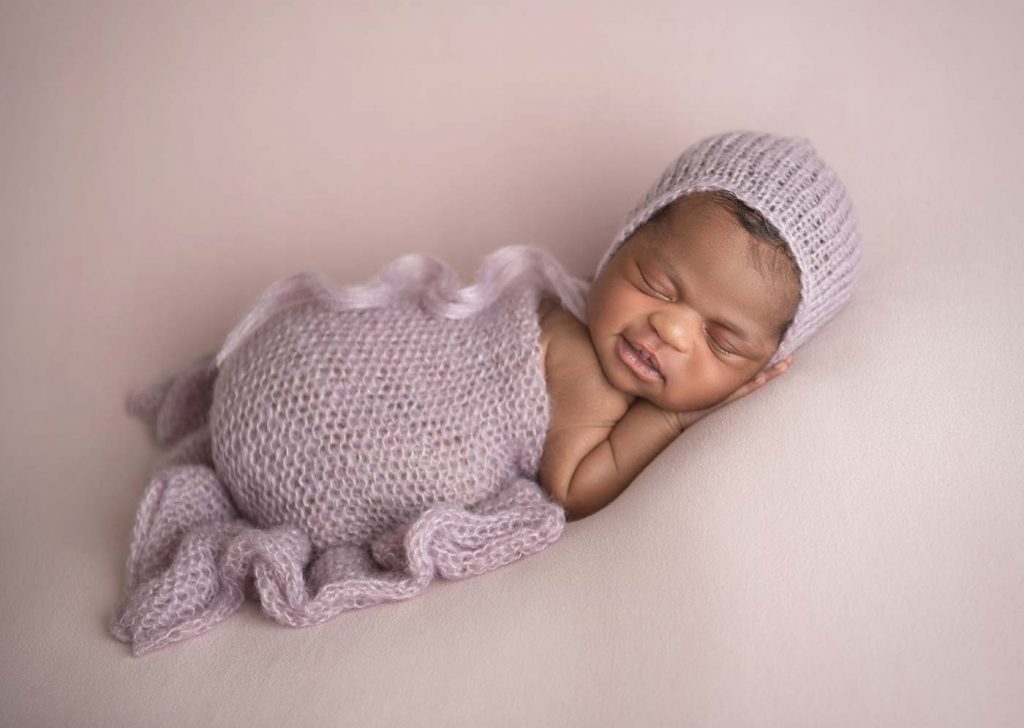 Sleeping infant with a knit blanket