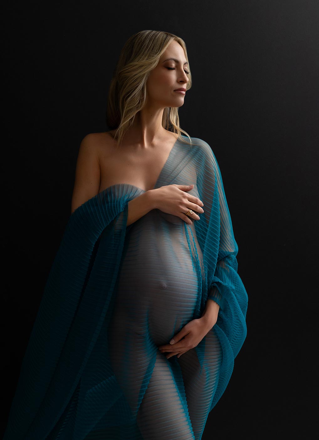transparent blue silk worn by a pregnant woman