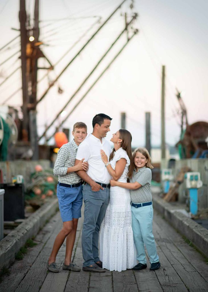 Lifestyle family portraits on dock with fishing boats