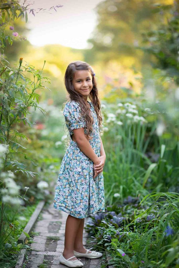 girl posing in Central Park gardens for Fall family photoshoot