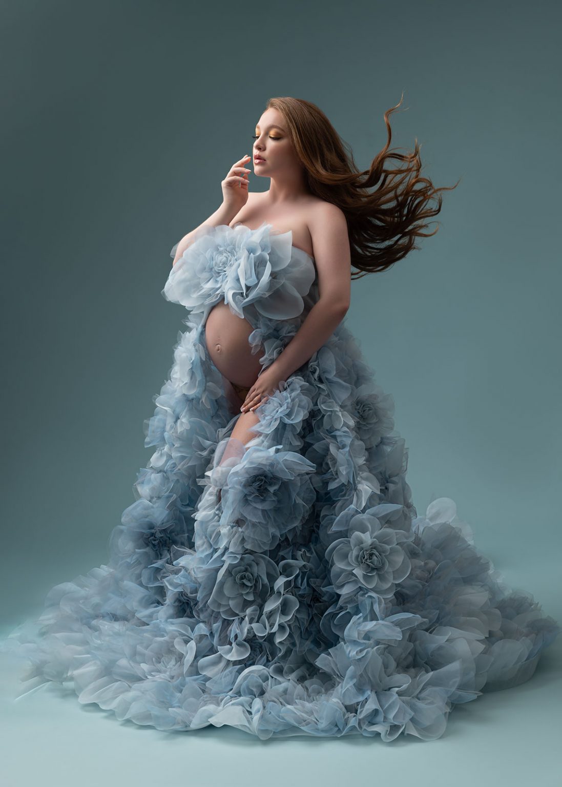 Luxury maternity photoshoot with blue floral ruffle dress