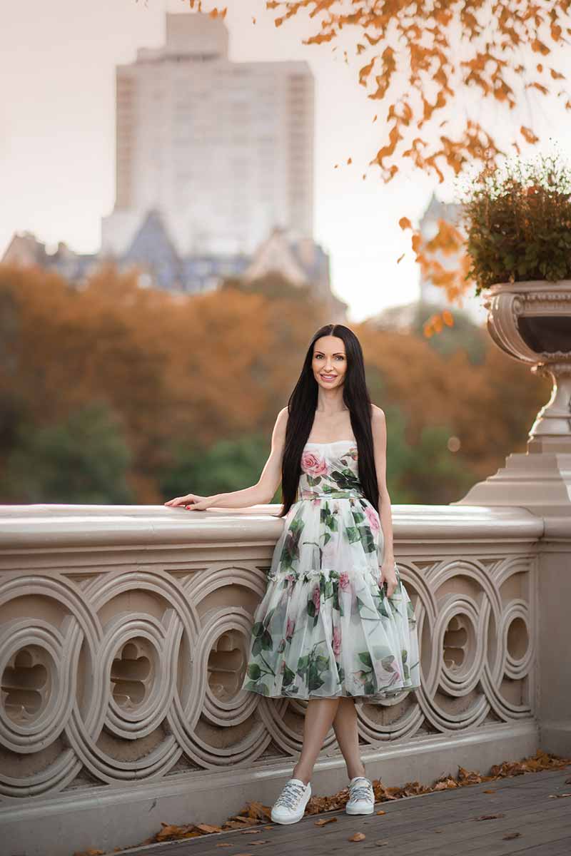 Teenage girl in a beautiful dress posing on a bridge in NYC