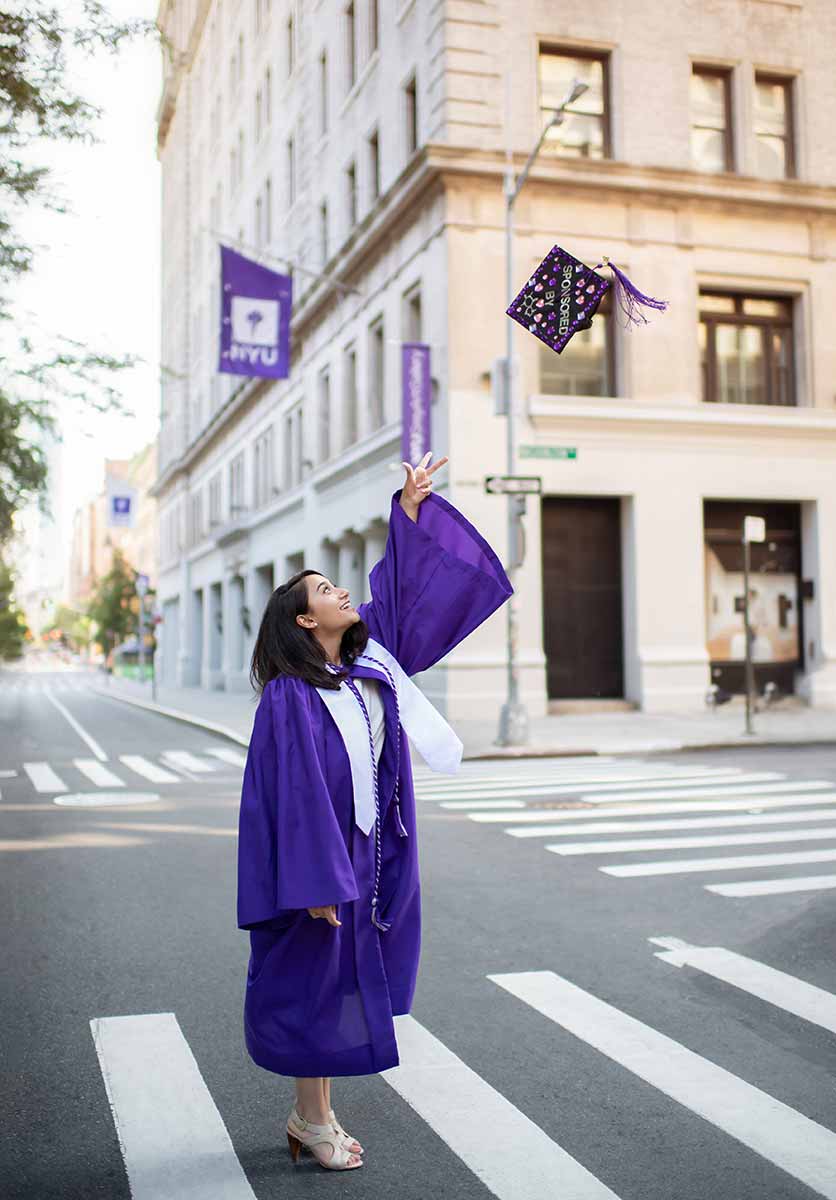 University student celebrating her graduation near Washington Square Park NYC