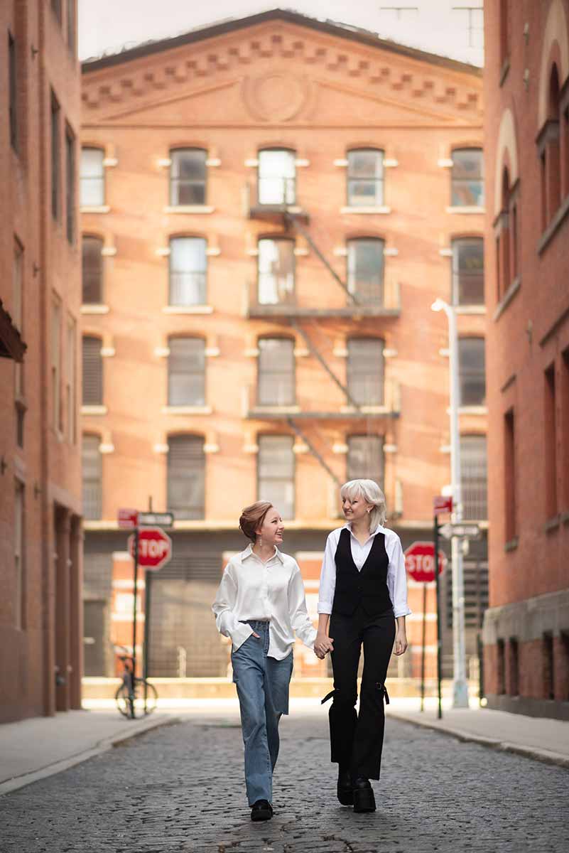 Teenage sisters walking down an alley in Tribeca neighborhood of New York City