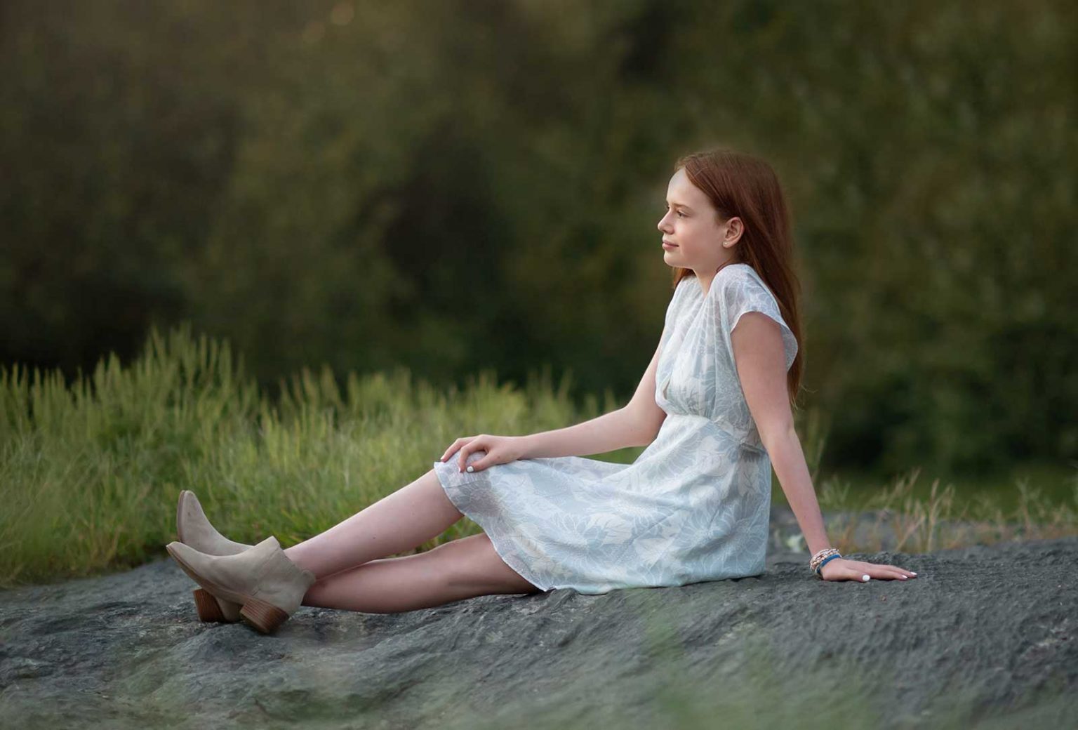 Teenage girl sitting on a rock in Central Park