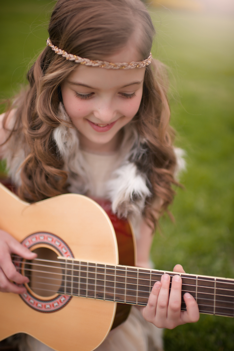 teenage girl playing guitar for lifestyle senior portraits