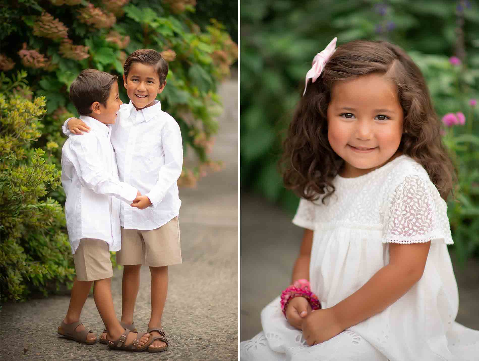 Left: Two young brothers stand outdoors in a garden, both wearing white shirts and beige shorts, with one boy hugging the other. Right: A young girl with wavy hair and a pink bow, dressed in a white dress, smiles while sitting on a bench amidst the greenery of Central Park.