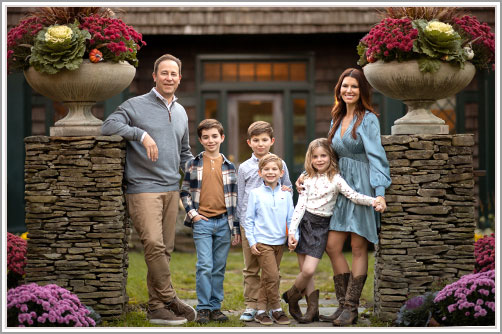 Modern family posing for a portrait in NYC Botanical Gardens