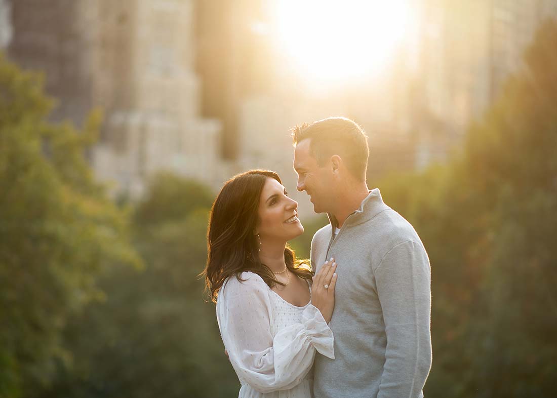 A romantic backlit portrait of husband and wife taken during sunset in NYC